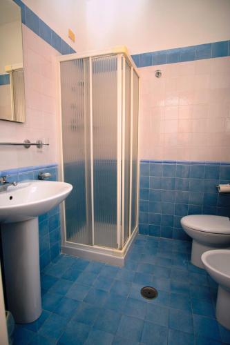 a bathroom with a shower and a toilet and a sink at Delfino in Marina di Camerota