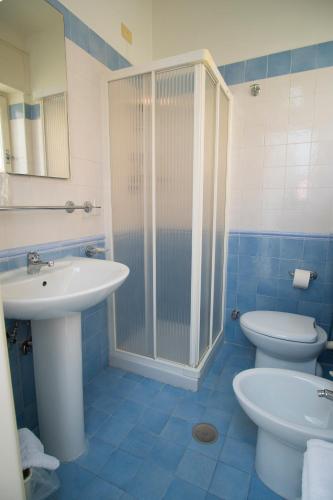 a bathroom with a sink and a shower and a toilet at Delfino in Marina di Camerota