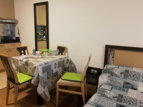 a dining room with a table and chairs and a bed at Emerald Beach Resort & Spa,studio ikat310 in Ravda