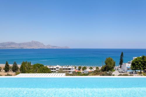 a view of the ocean from a swimming pool at Luxury Sunrise White Villa in Lindos