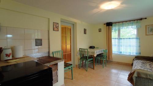 a kitchen and living room with a table and chairs at Zacisze in Hołuczków