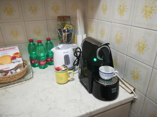 a kitchen counter with a coffee maker and a cup of coffee at Da Santina in Pieve Santo Stefano
