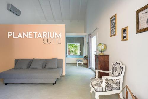 a living room with a couch and a chair at Naturarte Guesthouse in Terrasini