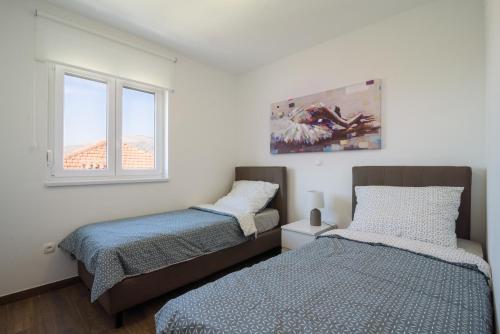 Postel nebo postele na pokoji v ubytování Luxury Apartman Ivana