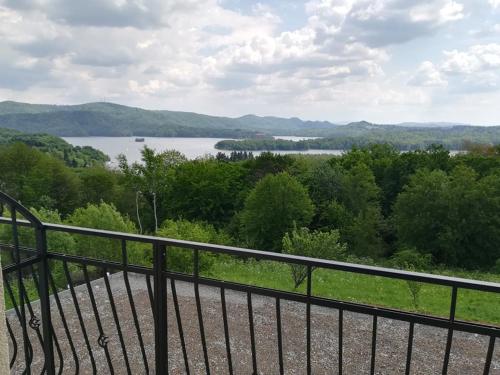 a balcony with a view of a lake at Willa Nova in Polańczyk