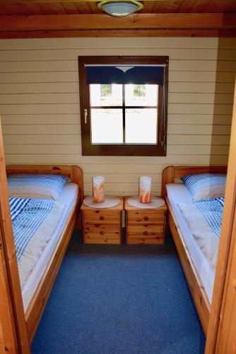 two twin beds in a room with a window at Blockhaus in Gnarrenburg