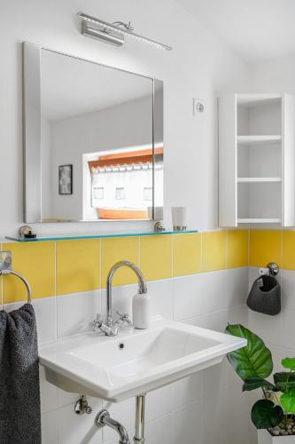 a bathroom with a sink and a mirror at Apartman Skroza in Vodice