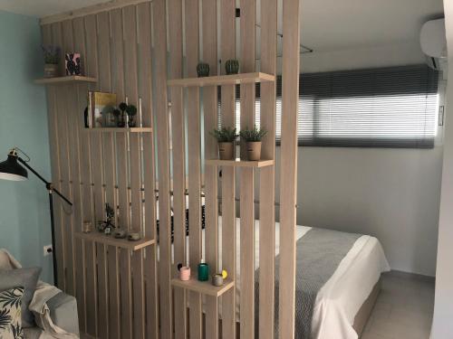 a bedroom with a book shelf with plants on it at ORFEAS SUITE in Nea Peramos