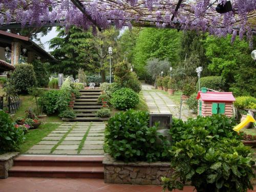 a garden with purple flowering plants and a building at Villa La Nina in Montecarlo