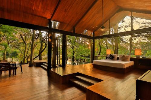 a bedroom with a bed in the middle of a room at Kalundewa Retreat in Dambulla
