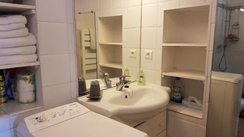 une salle de bain blanche avec un lavabo et un miroir dans l'établissement A Mandria, à Porticcio