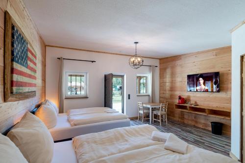 a hotel room with two beds and a tv at Zündstoff-City Western-Motel in Hemfurth-Edersee