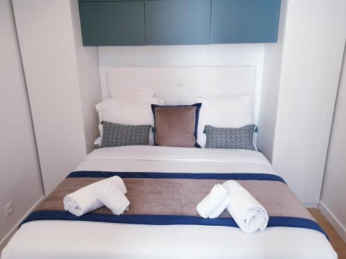 パリにあるアパートメント カルチェ ラタン ムフタールのタオルが備わる小さな部屋のベッド1台分です。