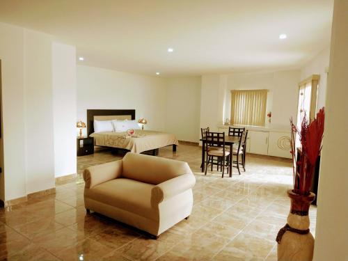 a living room with a couch and a bed and a table at BB INN in Nuevo Vallarta 