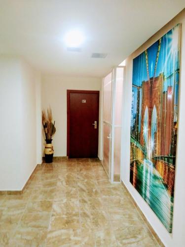 a hallway with a large painting on the wall at BB INN in Nuevo Vallarta 