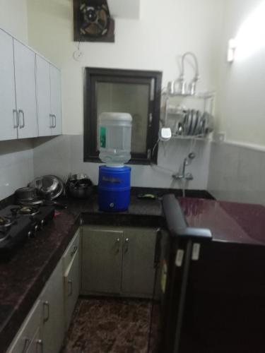 a kitchen with a sink and a counter top at The Raveesh E24 - 2BHK Serviced Apartment in New Delhi
