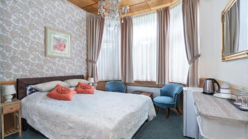 Gulta vai gultas numurā naktsmītnē Parus Boutique Hotel