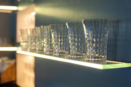 a row of glass vases sitting on a shelf at Rhombus Hotel in Luts'k