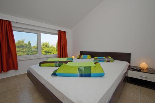 Un dormitorio con dos camas y una ventana. en Apartments Villa Natali - Heating Pool, en Trogir