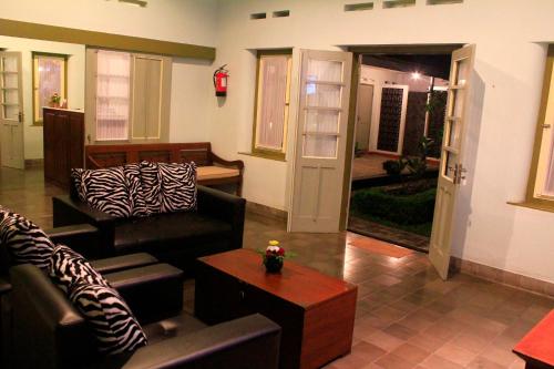 a living room with two couches and a table at The Kresna Hotel in Yogyakarta