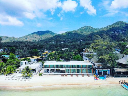 an aerial view of a building on a beach at Blue Tao Beach Hotel - SHA Plus in Koh Tao