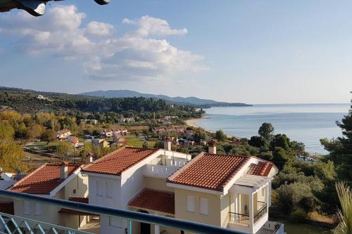 a view from the balcony of a house overlooking the ocean at PANORAMA HOUSE in Metókhion Konstamonítou