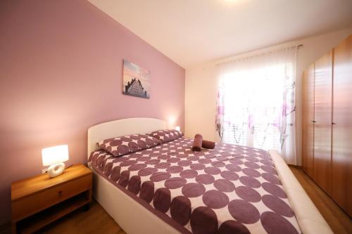 a bedroom with a large bed and a window at EasyLiving House near Zadar in Posedarje