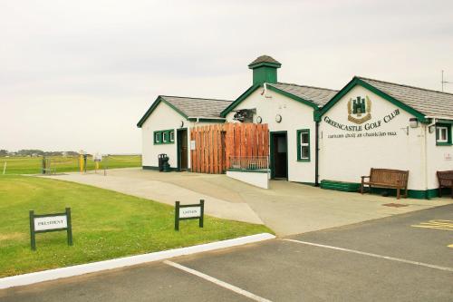 a building with two signs in front of it at Wild Atlantic View Inishowen in Greencastle