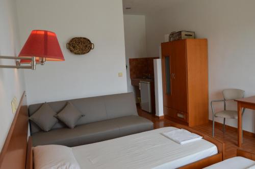 a living room with a couch and a table at Kostas Studios in Faliraki