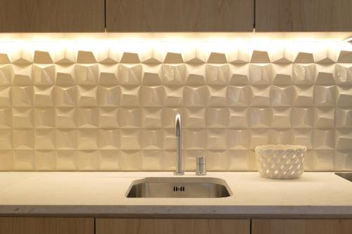 a kitchen counter with a sink and a counter top at Casas na Portuguesa - Bica Chiado in Lisbon