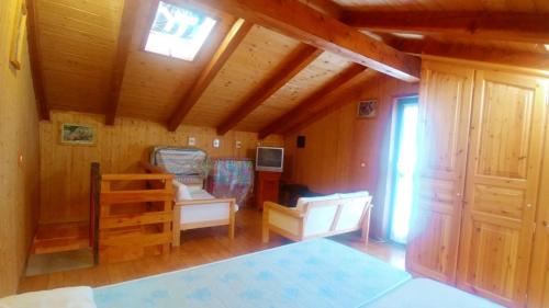 a room with wooden walls and a ceiling with a window at Casa Beatrice in Aprica