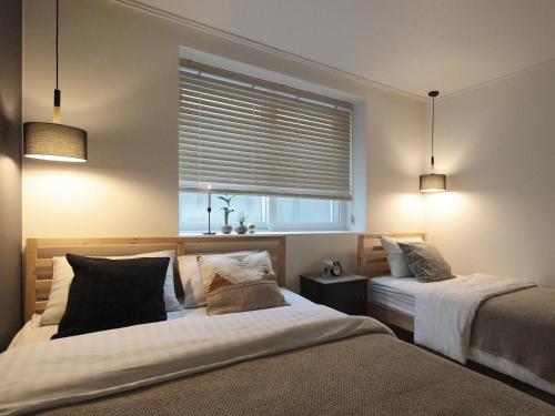 a bedroom with two beds and a window at Neat House in Seoul