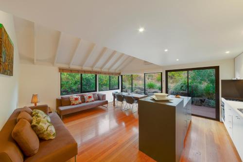 a living room with a couch and a table at Southern Ocean Villas in Port Campbell