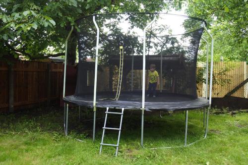a boy is standing on a trampoline at Tessedik Vendégház in Hajdúszoboszló