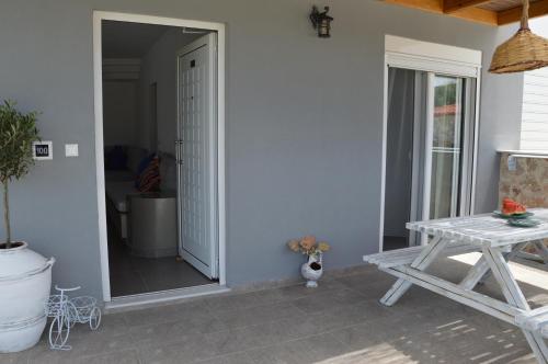 a room with a table and a mirror and a table at Kostas Studios in Faliraki
