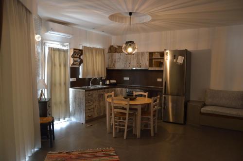 a kitchen with a table and a refrigerator at Kostas Studios in Faliraki