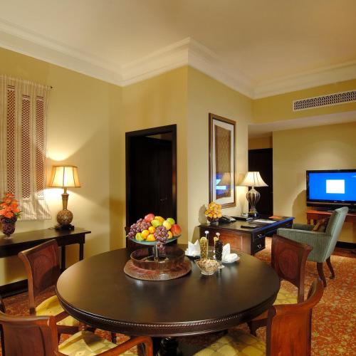 a living room with a table with a bowl of fruit at Djibouti Palace Kempinski in Djibouti