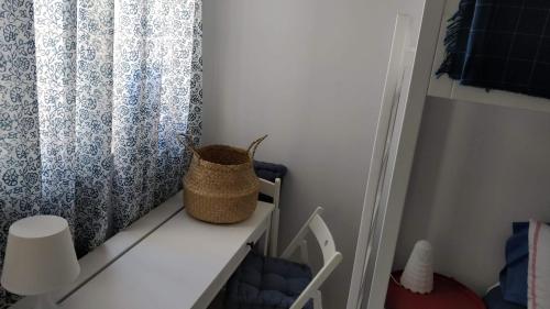 a room with a curtain and a white shelf at Little Blue House in Marsalforn