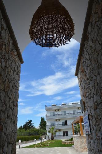 a view of a building from an archway at Kostas Studios in Faliraki