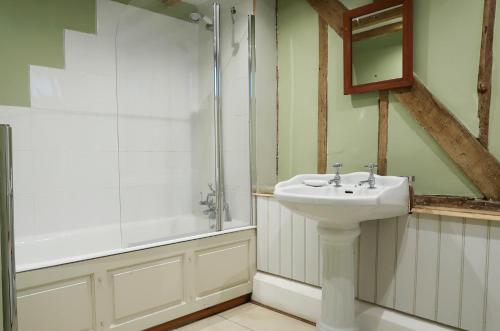a bathroom with a sink and a shower at Partridge Lodge Self Catering houses in Woodbridge