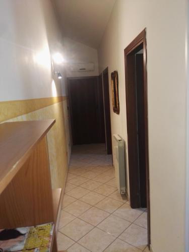 a hallway of a room with a door and a tile floor at Le mansarde di Via Isonzo in Chieti