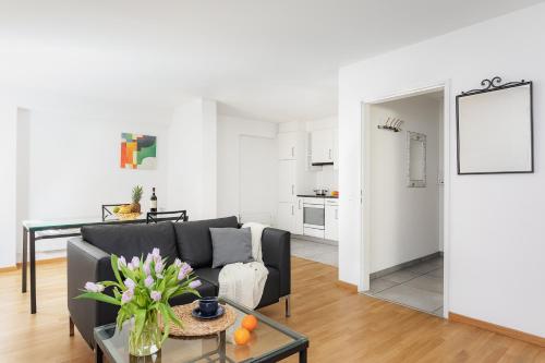 a living room with a couch and a table at Swiss Star Wiedikon - Self Check-In in Zurich