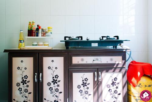 a kitchen with a cabinet with a stove top at Dream Borneo Budget Homestay Kota Kinabalu in Penampang