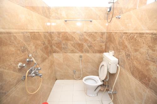 a bathroom with a shower and a toilet and a shower at YMCA SEACOM INN in Kolkata