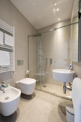 a bathroom with a toilet and a sink and a shower at Le Funi Hotel in Bergamo