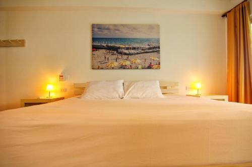 a hotel room with a bed and a lamp at Blue Mango Beach Hotel in Guachaca