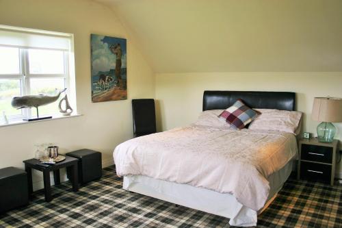 a bedroom with a large bed and a window at Wild Atlantic View Inishowen in Greencastle