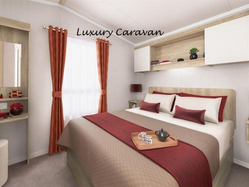 A bed or beds in a room at Inverbeg Holiday Park 