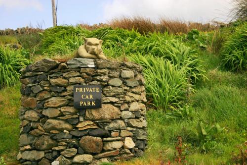 a statue of a monkey sitting on top of a stone wall at Wild Atlantic View Inishowen in Greencastle