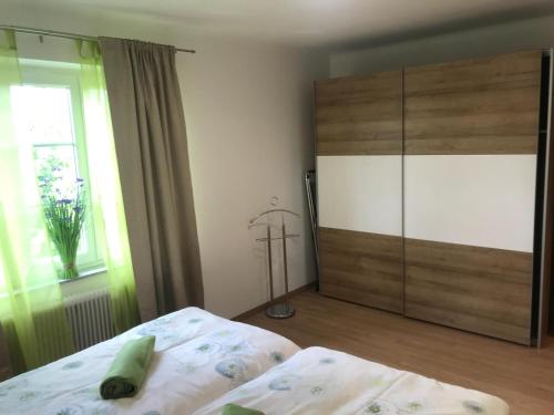 a bedroom with a bed and a dresser and a window at Wohnung am See in Steinbach am Attersee